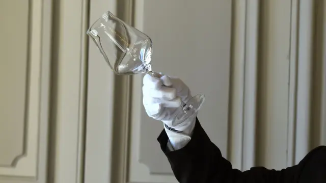 A man inspecting some glass