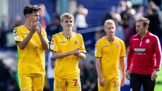 Bolton's young players applaud fans after their defeat at Tranmere