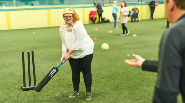 A woman hitting a ball