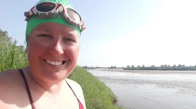 Melissa Compton by the river in swim cap