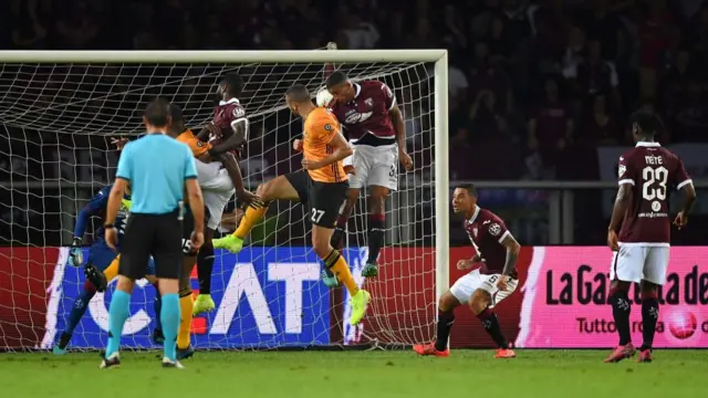 Romain Saiss (C) of Wolverhampton Wanderers scores the opening goal