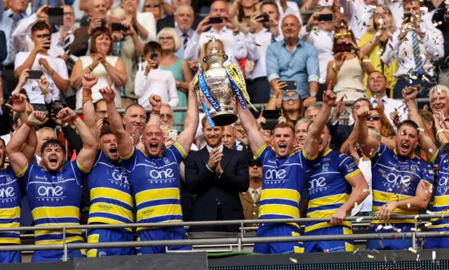 Warrington players celebrate in front of Prince Harry