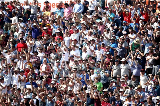 England fans celebrate after Ben Stokes hits a six during day four of the third Ashes Test match at Headingley