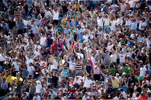 England fans hold their shoes up in support during day four of the third Ashes Test match at Headingley