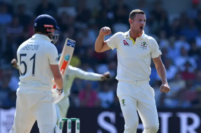 Australia's Josh Hazlewood (R) celebrates after taking the wicket of England's Jonny Bairstow (L) on the fourth day of the third Ashes cricket Test match between England and Australia at Headingley