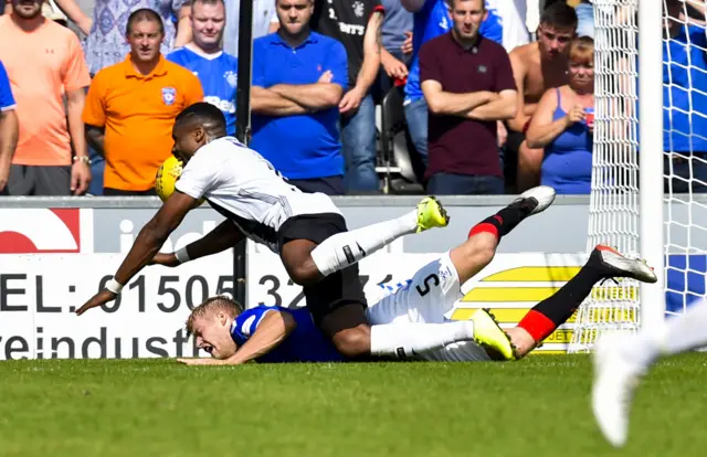 Obika goes down after being challenged by Helander in the box