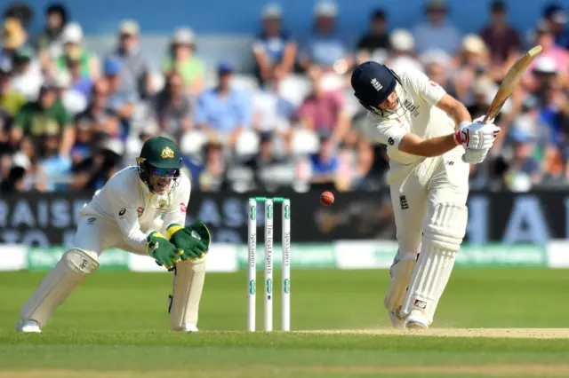 Joe Root (R) plays a shot to lose his wicket for 77 runs on the fourth day of the third Ashes cricket Test match between England and Australia at Headingley