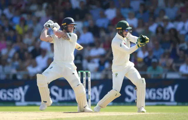 England batsman Ben Stokes cuts a ball to the boundary watched by Tim Paine during day four of the 3rd Ashes Test Match between England and Australia at Headingley