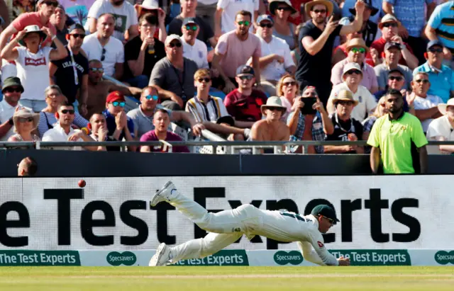 David Warner fails to stop the ball before the boundary as England"s Ben Stokes hits a four