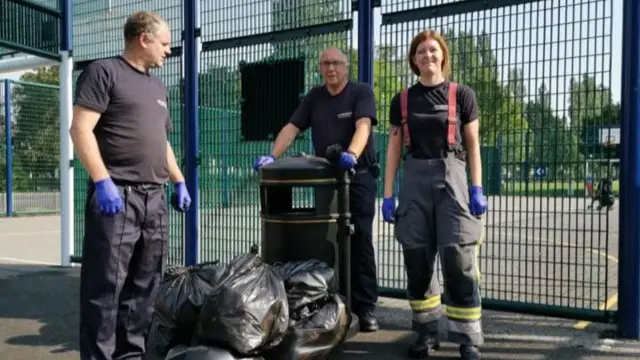 Fire fighters with rubbish collected for park