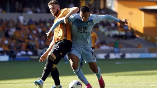 Wolverhampton Wanderers's Matt Doherty (left) and Burnley's Dwight McNeil battle for the ball