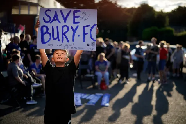 fans gather at Gigg Lane