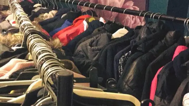 Rows of clothes on rails