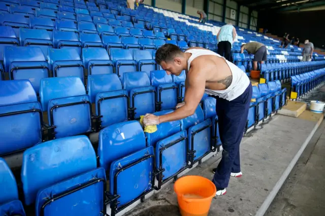 Fans clean Gigg Lane