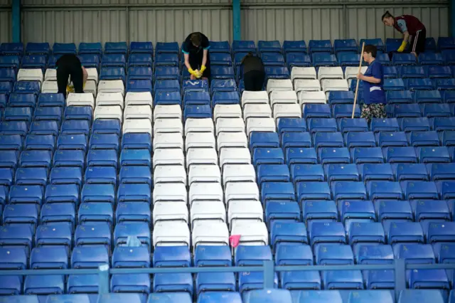 Fans clean Gigg Lane