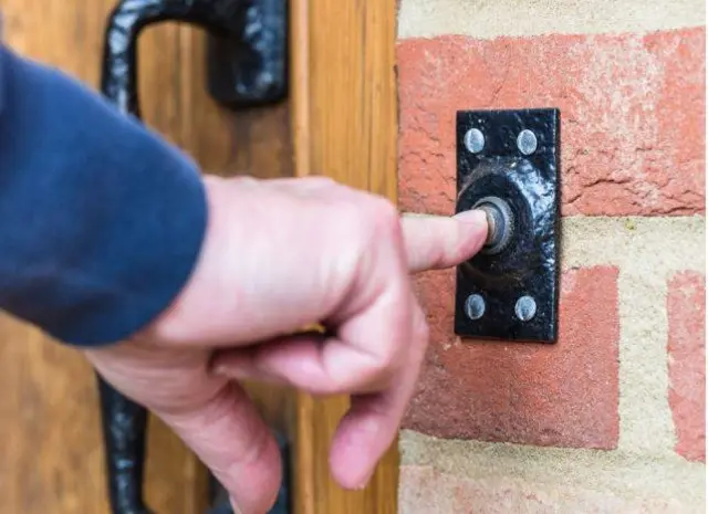 Person ringing doorbell