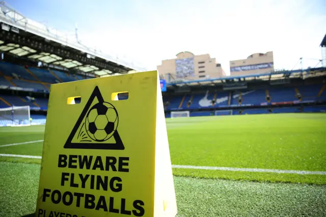 The Stamford Bridge pitch and a sign warning about flying footballs