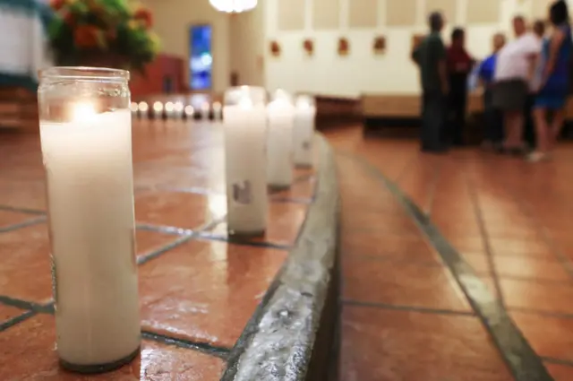 Candles honouring the 20 deceased