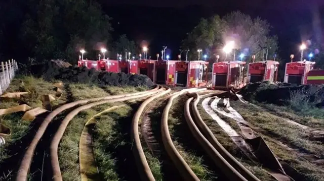 Fire engines being used to pump water