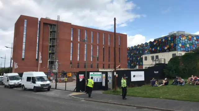 Workers sat outside the building today