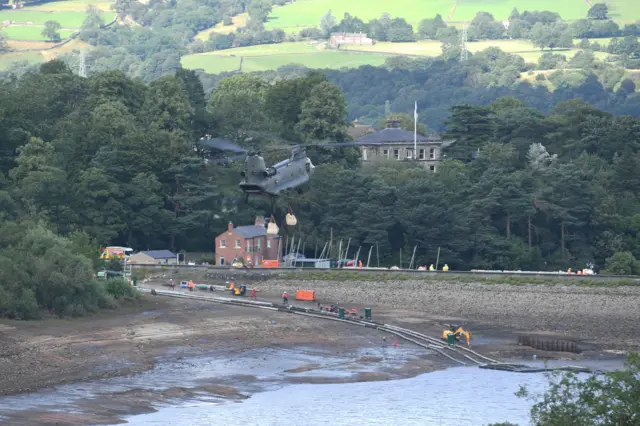 Work continues to shore up the dam at Toddbrook Reservoir near the village of Whaley Bridge