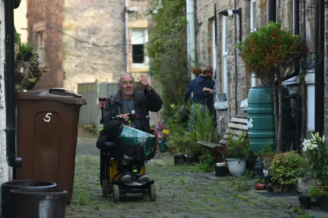 John Lomas returning to his home in Horwich End