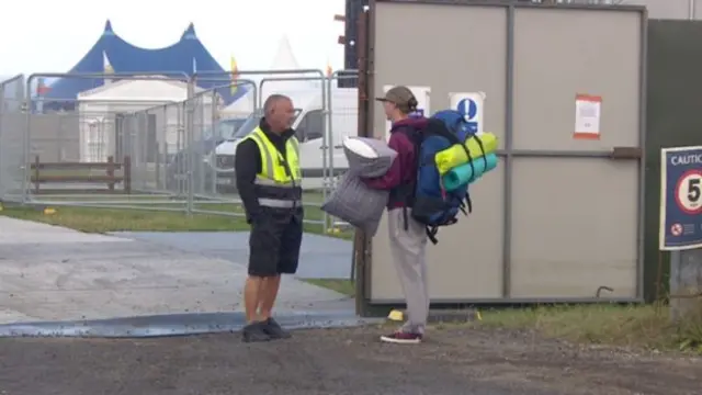 Festival-goer with camping gear