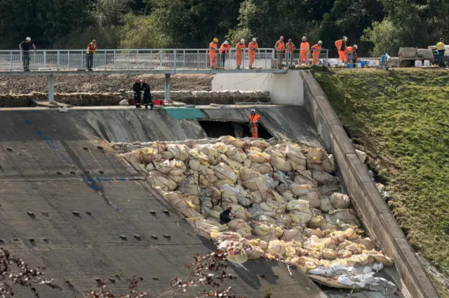 Engineers assess damaged dam