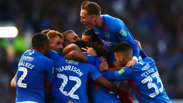 Ellis Harrison of Portsmouth celebrates with team-mates after scoring the opening goal