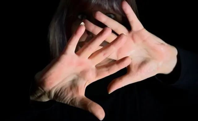 Hands in front of face