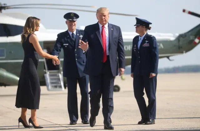 Trump and Melania approach air force 1