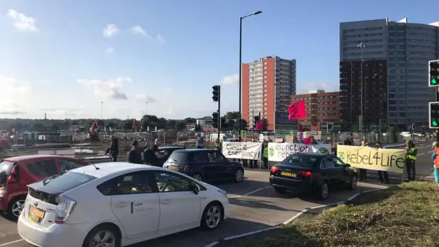 Cars being held up by protest