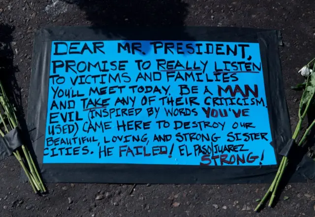 A message left for US President Tump before his August 7, 2019, visit at the makeshift memorial for victims of the shooting