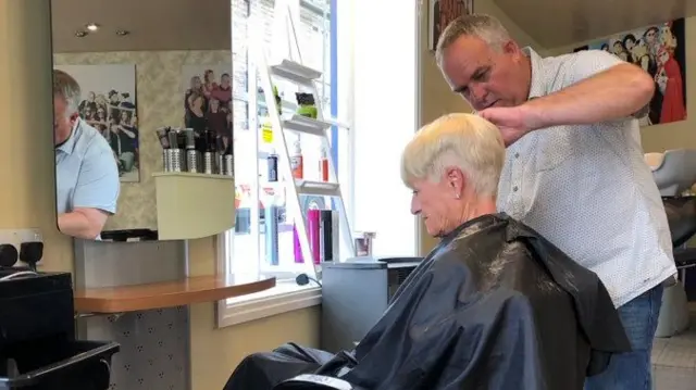 Woman having her hair cut