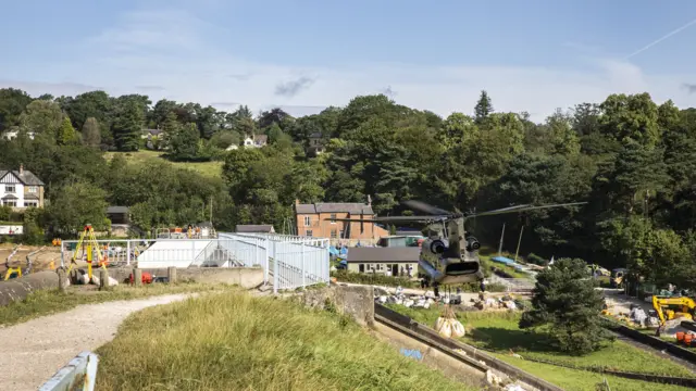 RAF Chinook flies over dam