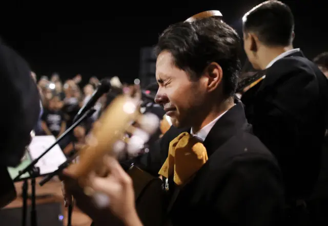 Sebastian Gonzalez becomes emotional while performing with his band Mariachi Puesta del Sol at the conclusion of an interfaith vigil for victims of a mass shooting,