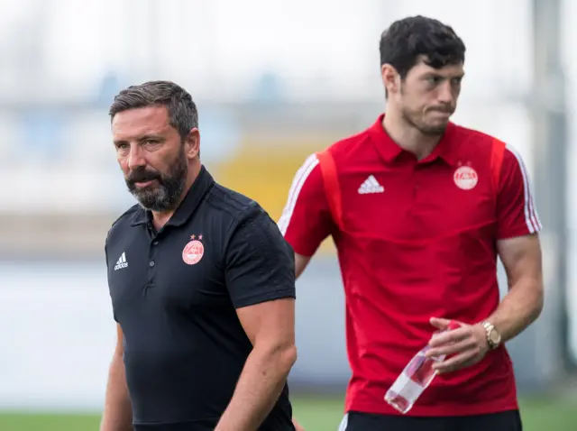Aberdeen manager Derek McInnes and unsettled defender Scott McKenna