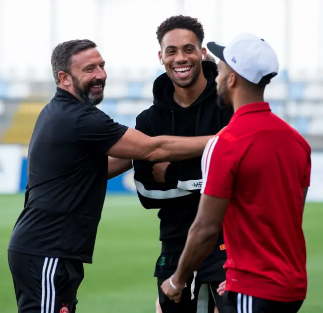 Aberdeen manager Derek McInnes shares a joke with new signing Zak Vyner