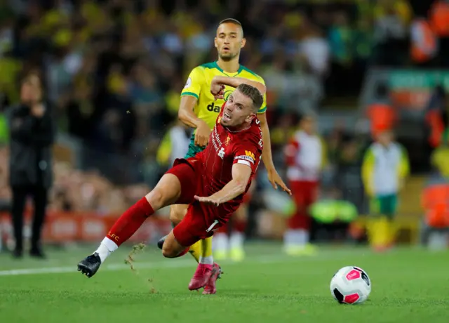 Jordan Henderson goes down under a challenge from Moritz Leitner