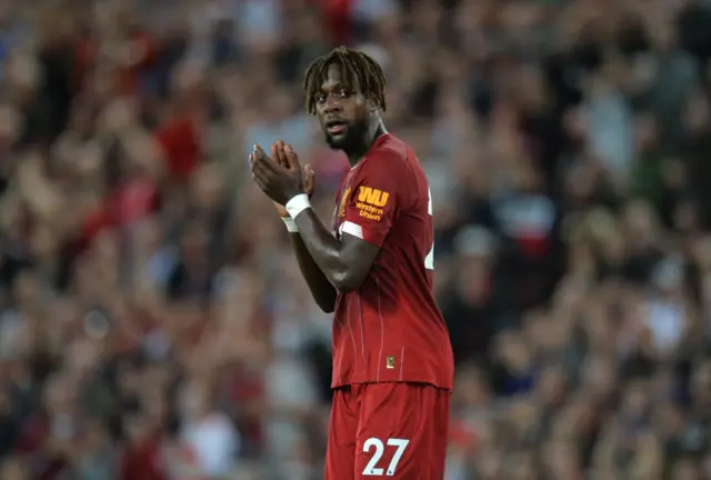 Divock Origi applauds the fans