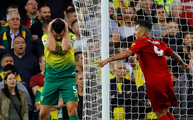 Greg Hanley with head in hands as Roberto Firmino celebrates