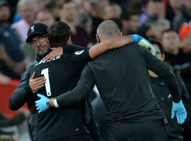 Jurgen Klopp hugs Alisson as he leaves the pitch