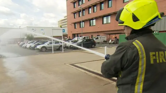 A firefighters with a hose