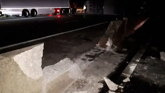 Damage to central barrier after lorry crashed and caught fire