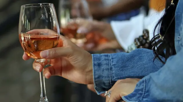 A woman with a glass of wine