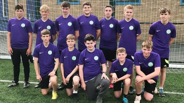 A group of referees in purple tops