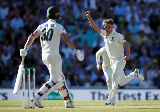 Sam Curran celebrates after taking the wicket of Australia"s Pat Cummins