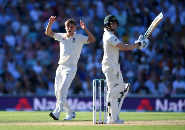 Sam Curran of England reacts as Steven Smith of Australia is dropped by England captain Joe Root during day two of the 5th Specsavers Ashes Test between England and Australia at The Kia Oval