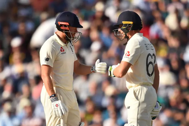 Jonny Bairstow (L) and England"s Jos Buttler chat during play on the third day of the fifth Ashes cricket Test match between England and Australia at The Oval