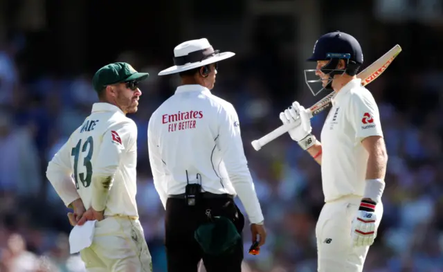 Australia's Matthew Wade and England's Joe Root speak to umpire Kumar Dharmasena